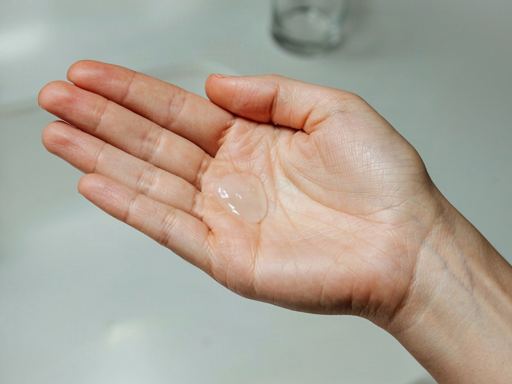 Open palm holding a pea-sized drop of water based moisturizer gel-cream