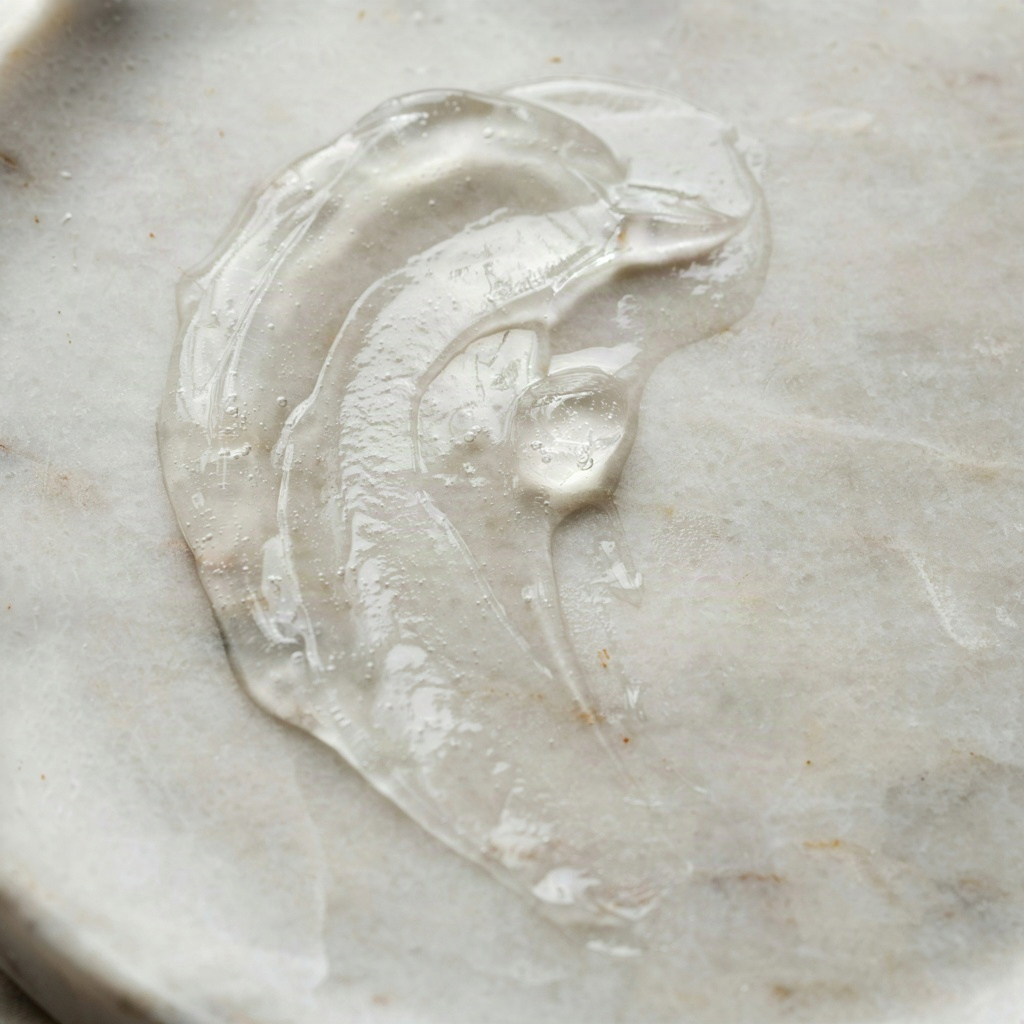 Thick swipe of clear occlusive ointment on pale stone, the healing step for lips too damaged to scrub