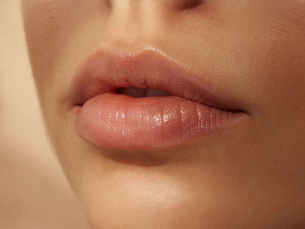 Close-up of smooth hydrated lips showing the subtle volume a lip plumper creates